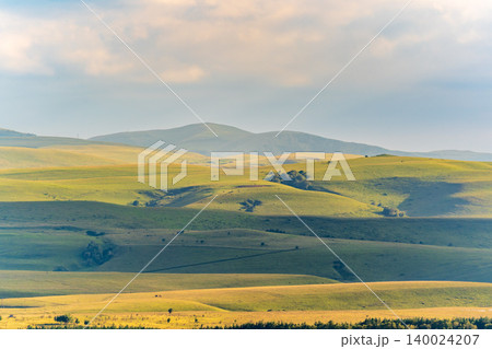 Layers of green mountains and hills in the haze during sunset. Panoramic View of Green hills and Meadow. Layers of green mountains and hills in the haze during sunset. Panoramic View of Green hills and Meadow. 140024207