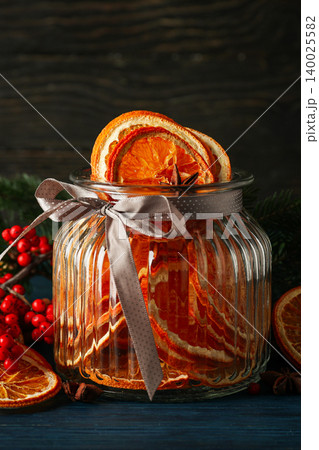 Dried orange slices are arranged in a glass jar with twine Dried orange slices are arranged in a glass jar with twine 140025582