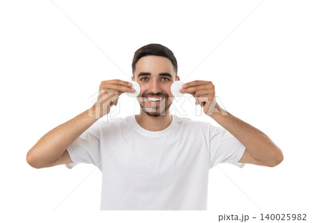 Man smiling while holding cotton pads on his face, isolated, PNG Man smiling while holding cotton pads on his face, isolated, PNG 140025982