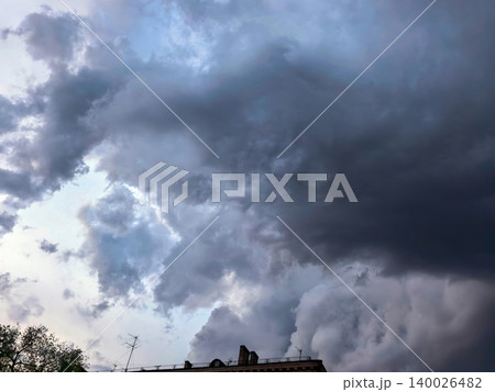 Heavy Storm Clouds Above Urban Rooftops At Dusk 140026482