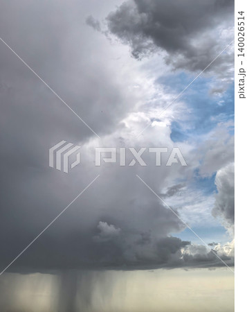Dark Thundercloud With Rain Shaft And Blue Sky Dark Thundercloud With Rain Shaft And Blue Sky 140026514
