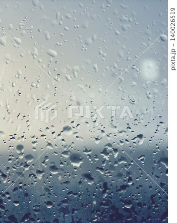 Blue toned rain drops on glass texture Blue toned rain drops on glass texture 140026519