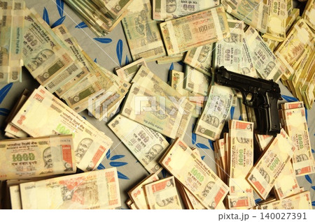Indian Currency Gun on Bed Indian Currency Gun on Bed 140027391