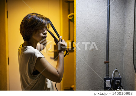 Asian Woman Using Steam Iron To Press Clothes, housewife ironing apparel for laundry service marketing campaign, brand awareness, domestic garment care and home appliance lifestyle utility. Asian Woman Using Steam Iron To Press Clothes, housewife ironing apparel for laundry service marketing campaign, brand awareness, domestic garment care and home appliance lifestyle utility. 140030998