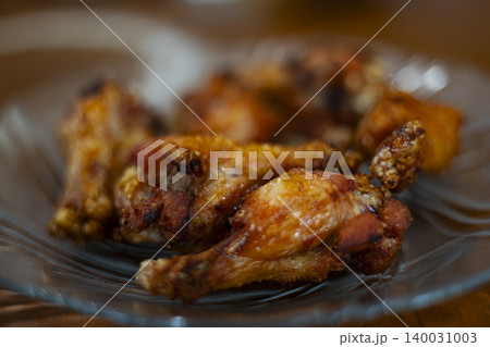 Crispy Golden Fried Chicken Served On A Glass Plate, delicious fast food snack for restaurant menu marketing campaign, brand awareness, unhealthy eating nutrition and culinary lifestyle. 140031003
