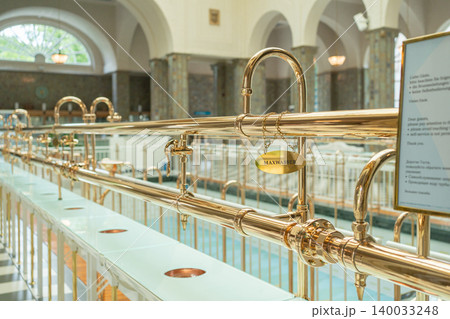 Elegant drinking pavilion with golden water taps designed for balneotherapy treatments. High-quality commercial photo representing premium medical wellness tourism and sanatorium care 140033248