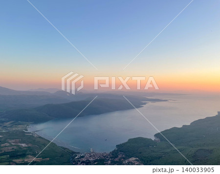 Aerial Sunset View over Lake and Mountain Range 140033905