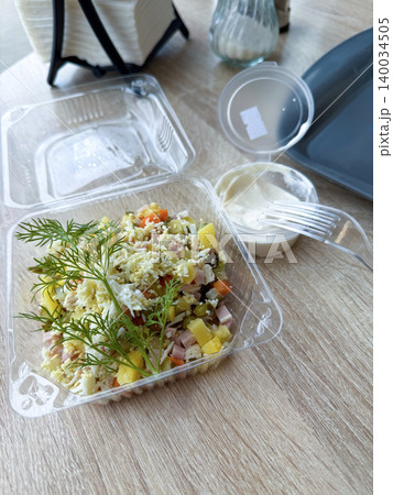 Salad in a disposable plastic container. Salad in a disposable plastic container. 140034505