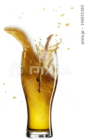 Female dancer splashing into tall beer glass with foam wave and droplets. 140035365