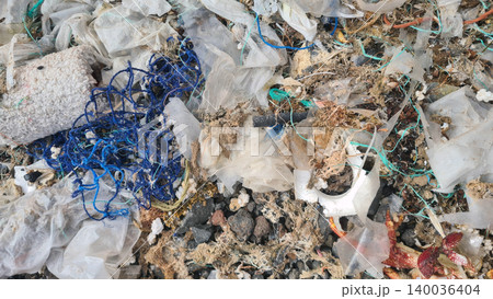Plastic waste and microplastics cover the beach, causing severe ecological damage to marine life and coastlines 140036404