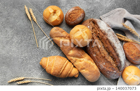 Freshly baked bread assortment with wheat ears Freshly baked bread assortment with wheat ears 140037073