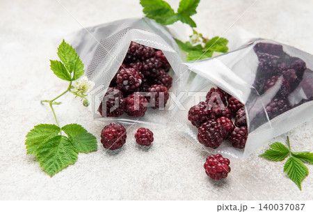 Frozen blackberries in vacuum bags for food preservation Frozen blackberries in vacuum bags for food preservation 140037087