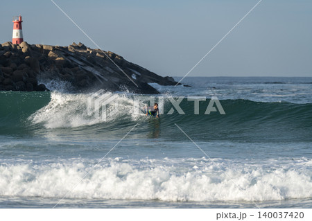 Bodyboarder riding a wave 140037420