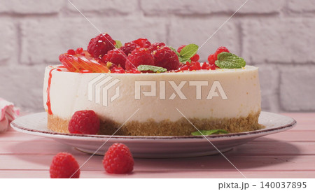 Cheesecake with fresh raspberries and plums Cheesecake with fresh raspberries and plums 140037895