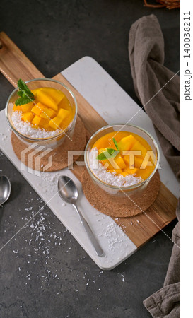 Two Glasses of Mango Chia Seed Pudding with Coconut and Mint 140038211