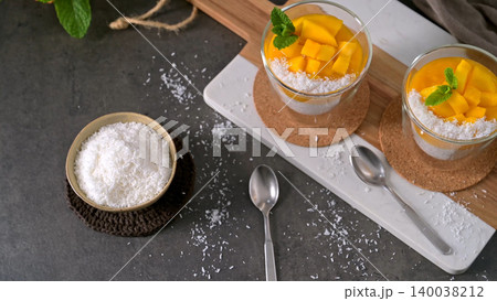 Two Glasses of Mango Chia Pudding with Coconut Flakes and Fresh Mint Two Glasses of Mango Chia Pudding with Coconut Flakes and Fresh Mint 140038212