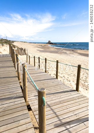 Wooden Boardwalk at Miramar Beach with Senhor da Pedra Chapel 140038232