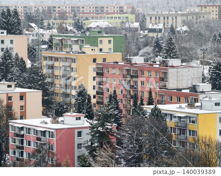 Colorful apartment buildings in winter. Snowcovered houses in busy yet peaceful winter setting 140039389