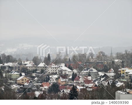 Misty hills overlook peaceful village life. Tranquil town with church spire and rolling misty hills Misty hills overlook peaceful village life. Tranquil town with church spire and rolling misty hills 140039390