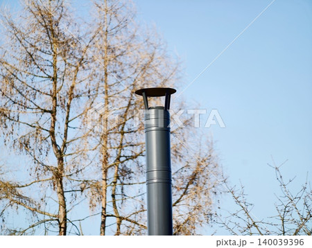Cold winter scene. Rural chimney against blue sky. Minimalist image of winter chimney and branches 140039396