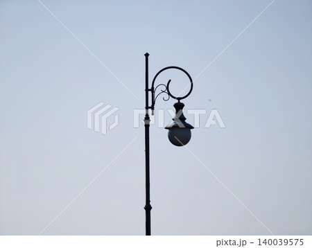 Dark street scene with stark shadows. Moonlit cityscape highlighting shadows and solitary mood Dark street scene with stark shadows. Moonlit cityscape highlighting shadows and solitary mood 140039575