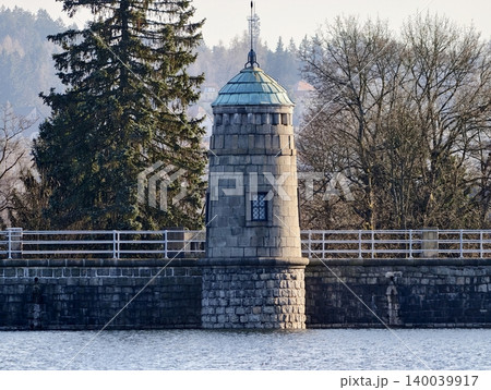 Serene winter landscape. Calm dam overlooking silent lake. Tranquil scene with engineer and mirror reflections 140039917