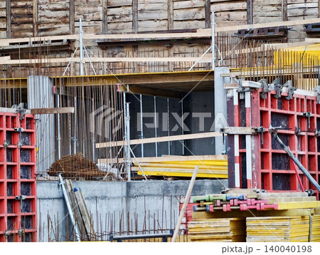 Construction site overview. Industrial building in progress. Urban construction with scaffolding and materials 140040198
