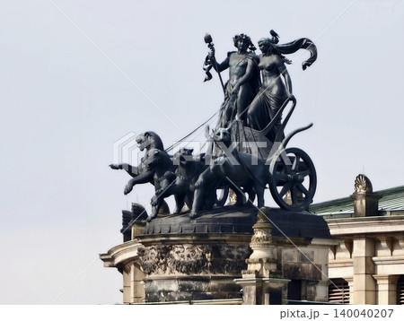 Classical allegory with modern city skyline. Dramatic bronze figures on rooftop with urban backdrop Classical allegory with modern city skyline. Dramatic bronze figures on rooftop with urban backdrop 140040207