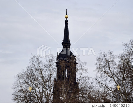 Observation point captures contrast between tall spire and leafless branches during season Observation point captures contrast between tall spire and leafless branches during season 140040216