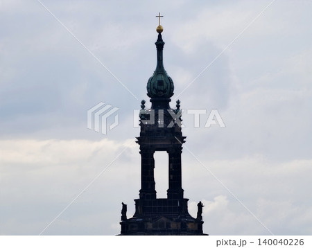 Clock tower inspection. Evaluation of masonry and patina on historic bell tower under cloudy sky Clock tower inspection. Evaluation of masonry and patina on historic bell tower under cloudy sky 140040226