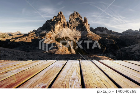 Wooden deck foreground The sunlight covers the rocks. Tre Cime di Lavaredo mountains, majestic view of the popular place, nature background Wooden deck foreground The sunlight covers the rocks. Tre Cime di Lavaredo mountains, majestic view of the popular place, nature background 140040269