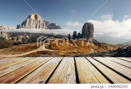 Wooden deck foreground Great autumn view of the top Tofana di Rozes and Cinque Torri range in Dolomites, South Tyrol. Location Cortina d'Ampezzo, Italy, Europe. Beauty of mountains world. Wooden deck foreground Great autumn view of the top Tofana di Rozes and Cinque Torri range in Dolomites, South Tyrol. Location Cortina d'Ampezzo, Italy, Europe. Beauty of mountains world. 140040293