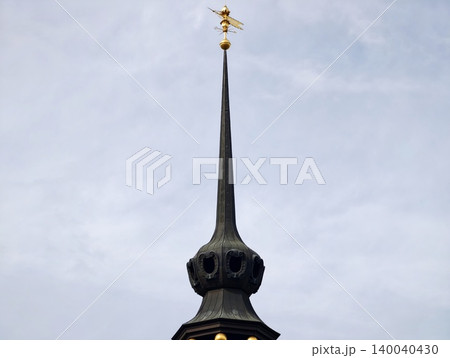 Moodily lit towering spire. Sleek vertical monument with hidden lighting effects and mysterious aura Moodily lit towering spire. Sleek vertical monument with hidden lighting effects and mysterious aura 140040430