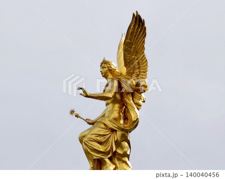 Gilded angel wings. Sculpted gilded angel wings with intricate feather textures displayed clearly 140040456