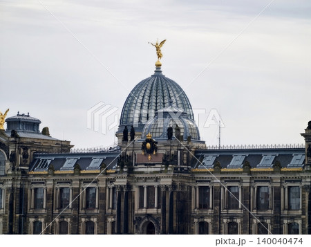 Historic museum rooftop. Cultural landmark featuring golden sculpture and detailed masonry structure 140040474
