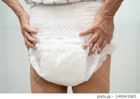 Asian senior woman patient wearing adult incontinence diaper pad in hospital. Asian senior woman patient wearing adult incontinence diaper pad in hospital. 140041665