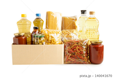 Foodstuffs in donation box isolated on white background. Foodstuffs in donation box isolated on white background. 140041670