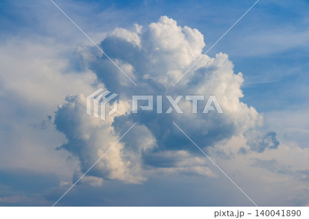 Fluffy white cumulus cloud floating in the clear blue sky, a majestic bright heaven formation capturing the pure summer atmosphere and peaceful serenity of a sunny bright day Fluffy white cumulus cloud floating in the clear blue sky, a majestic bright heaven formation capturing the pure summer atmosphere and peaceful serenity of a sunny bright day 140041890