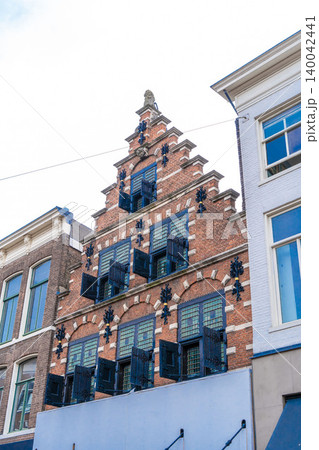 Haarlem, the Netherlands - March, 2022: Cozy Street view and generic architecture in Haarlem with typical Dutch style buildings. Haarlem, the Netherlands - March, 2022: Cozy Street view and generic architecture in Haarlem with typical Dutch style buildings. 140042441