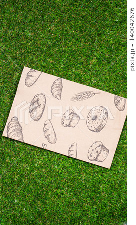 brown paper bag on Green Bush Trees Foliage Background. Eco Nature Friendly Style,Go to zero waste ecological shopping bag on the green grass. An alternative to disposable packages. Zero waste concept brown paper bag on Green Bush Trees Foliage Background. Eco Nature Friendly Style,Go to zero waste ecological shopping bag on the green grass. An alternative to disposable packages. Zero waste concept 140042676