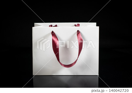 Recyclable craft paper bag for purchases, gifts and takeaway food mock up on black background. Environmentally friendly than single-use plastic bags Recyclable craft paper bag for purchases, gifts and takeaway food mock up on black background. Environmentally friendly than single-use plastic bags 140042720