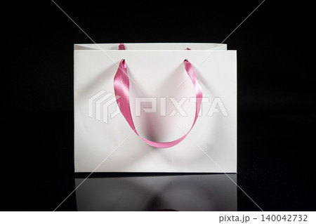 Recyclable craft paper bag for purchases, gifts and takeaway food mock up on black background. Environmentally friendly than single-use plastic bags Recyclable craft paper bag for purchases, gifts and takeaway food mock up on black background. Environmentally friendly than single-use plastic bags 140042732