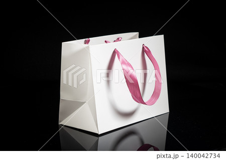 Recyclable craft paper bag for purchases, gifts and takeaway food mock up on black background. Environmentally friendly than single-use plastic bags Recyclable craft paper bag for purchases, gifts and takeaway food mock up on black background. Environmentally friendly than single-use plastic bags 140042734