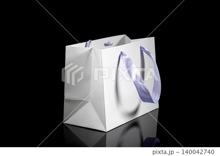 Recyclable craft paper bag for purchases, gifts and takeaway food mock up on black background. Environmentally friendly than single-use plastic bags 140042740