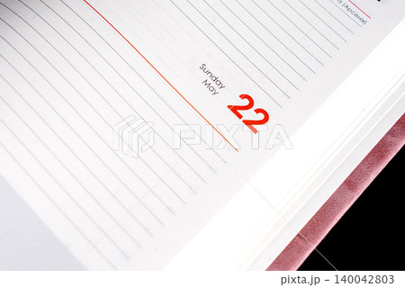 close up of a blank velour fluffy notebook with opened pages 22 May on black background with clipping path close up of a blank velour fluffy notebook with opened pages 22 May on black background with clipping path 140042803