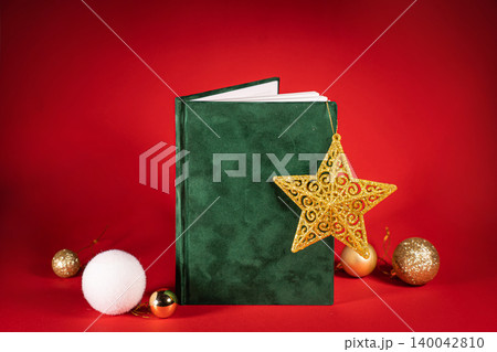 close up of a green velour fluffy notebook on red christmas background with clipping path close up of a green velour fluffy notebook on red christmas background with clipping path 140042810