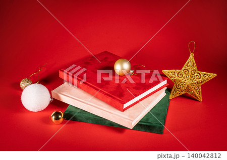 close up of a green and red tho velour fluffy notebooks on red christmas background with clipping path 140042812