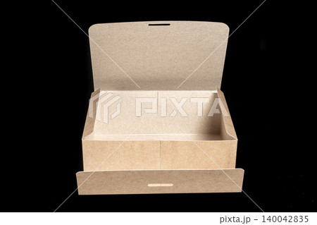 Opened cardboard unfolded box isolated on black background Opened cardboard unfolded box isolated on black background 140042835