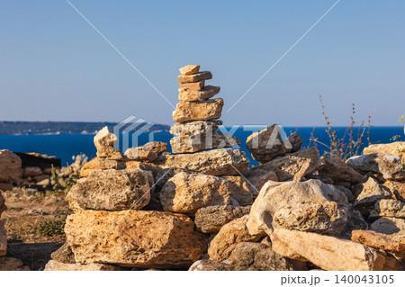 Stacked stone cairn on coastal rocks with Black Sea view at Cape Kaliakra Bulgaria Stacked stone cairn on coastal rocks with Black Sea view at Cape Kaliakra Bulgaria 140043105