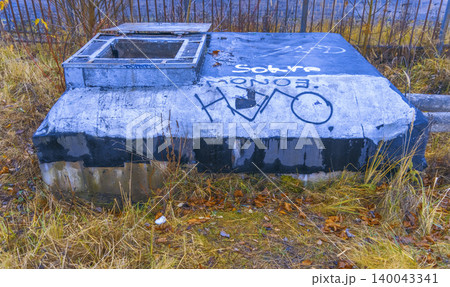 Rusty metal and overgrown grass setting. Moodful autumn scene with textured urban decay background Rusty metal and overgrown grass setting. Moodful autumn scene with textured urban decay background 140043341
